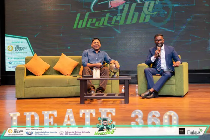 Mayantha hosting a panel discussion on stage at IDEATE 360