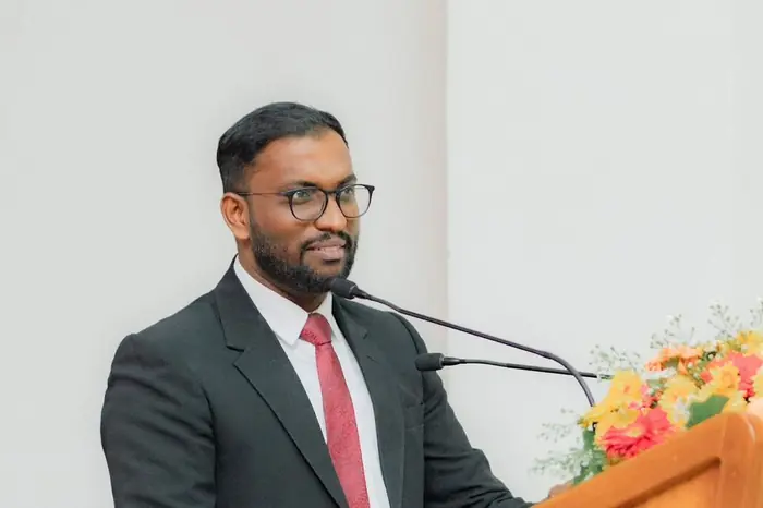 Mayantha speaking at a podium for the Law Students' Association of Sri Lanka