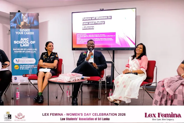 Mayantha Warnakulasooriya moderating a panel discussion on stage at the Law Students' Association of Sri Lanka's Lex Femina event, holding a microphone while engaging with guest speakers and the audience.
